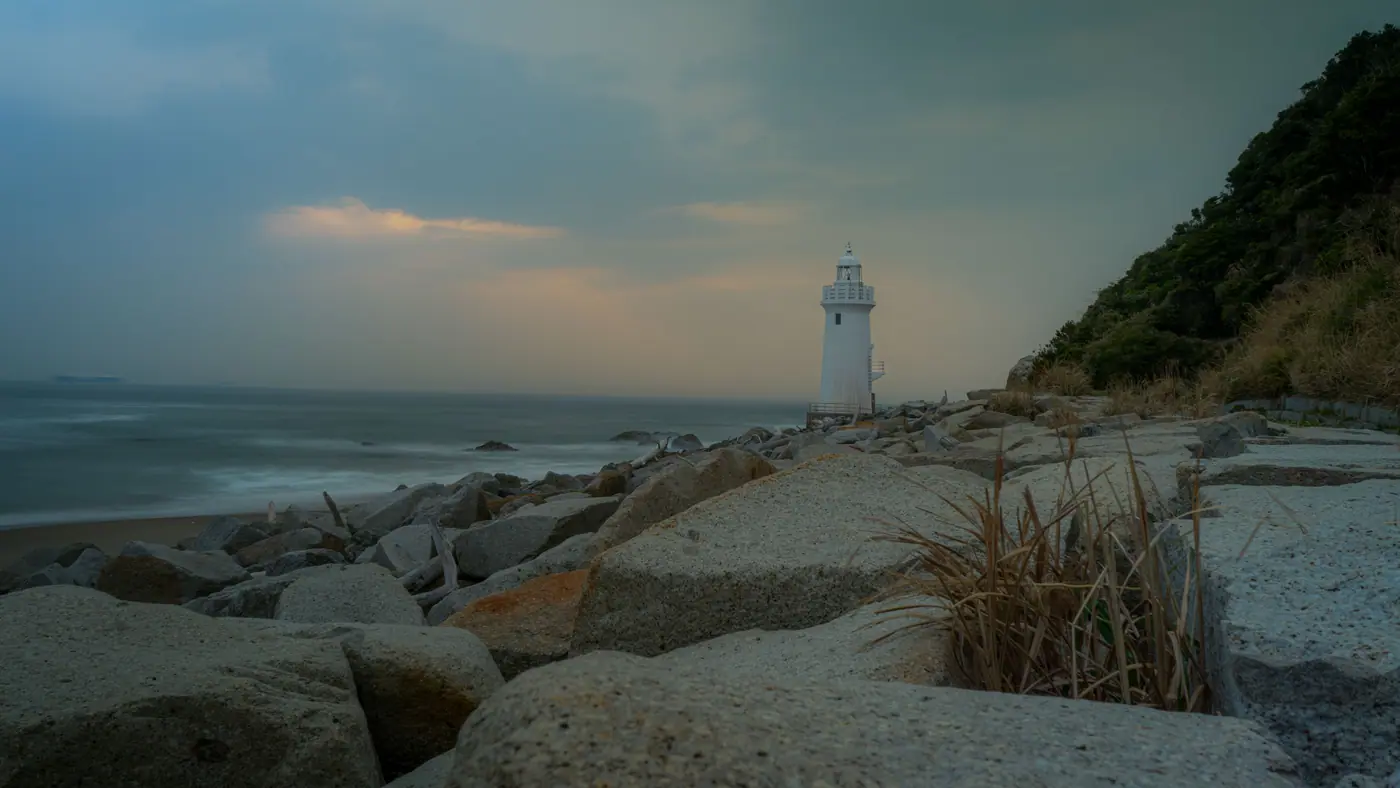 Irago Lighthouse at dusk seen from the breakwater rocks