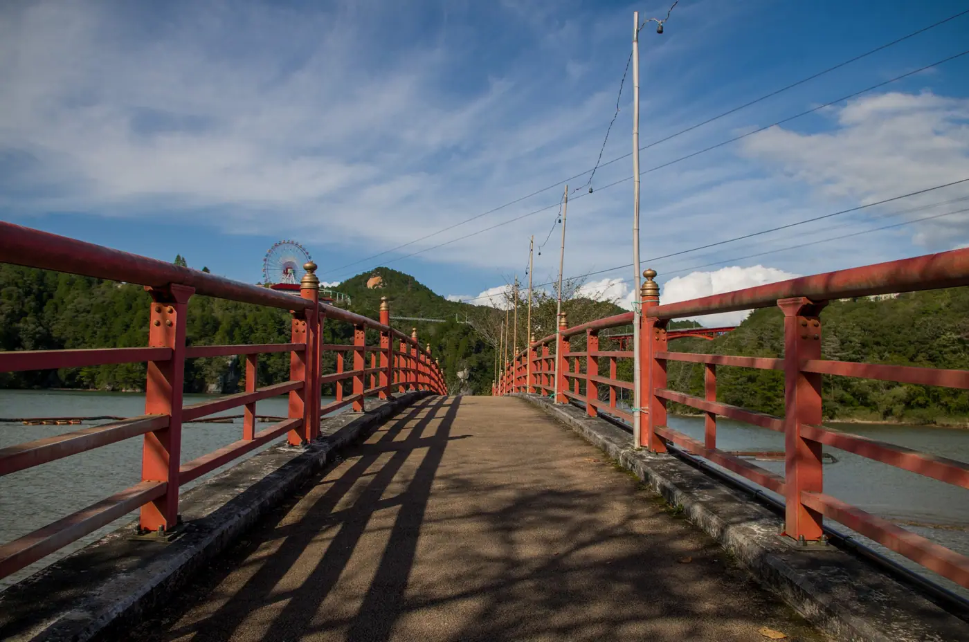 A red-railed walkway over the lake at Enakyo
