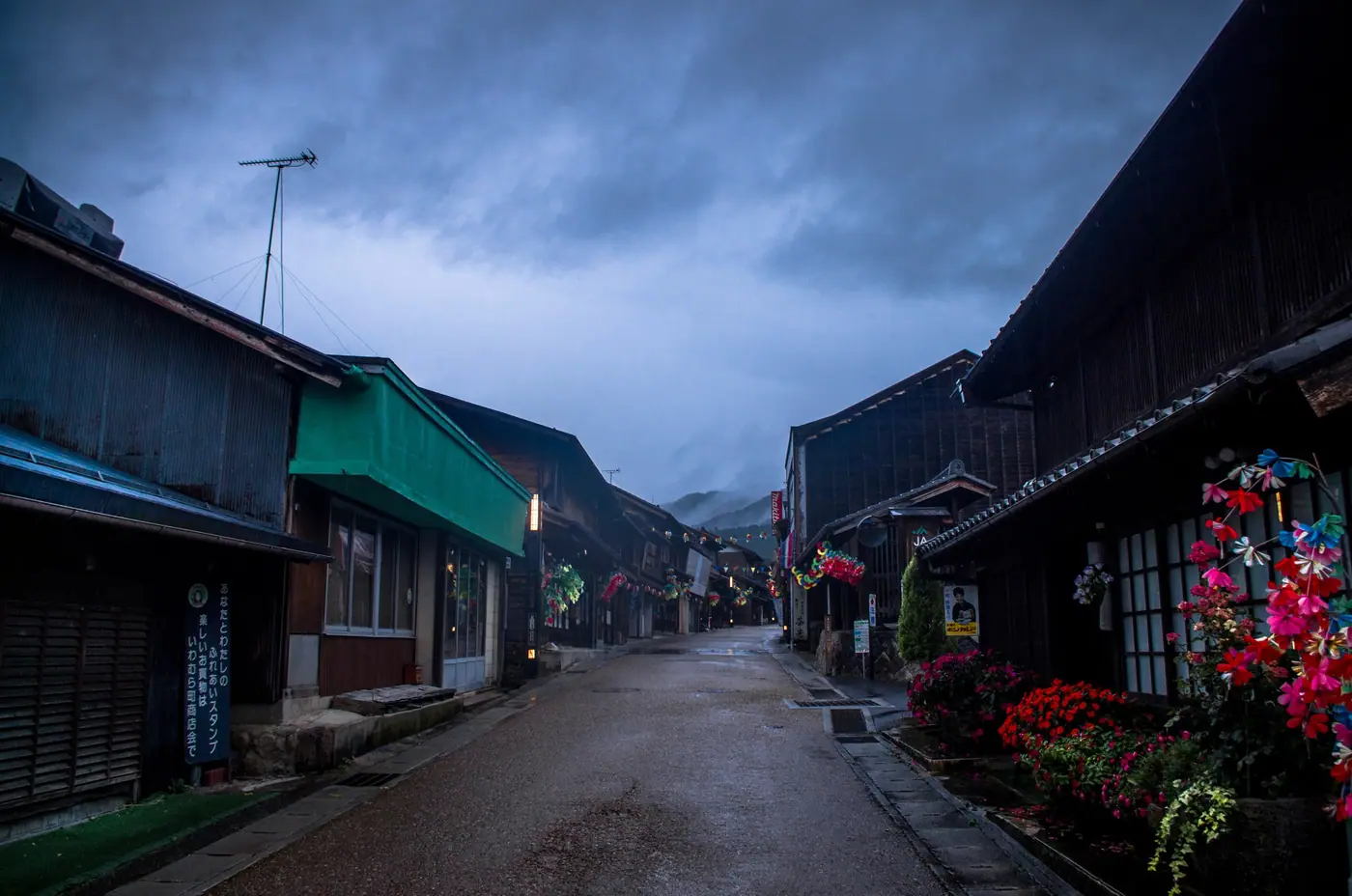 The old castle-town street in Iwamura at dusk, lined with wooden shops